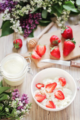 Healthy breakfast with strawberry, cottage cheese, honey and cre