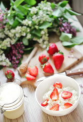Healthy breakfast with strawberry, cottage cheese, honey and cre