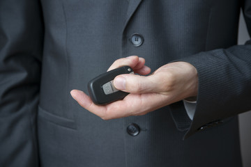 Businessman using car key