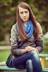 Obraz premium Trendy young woman in jeans and a scarf