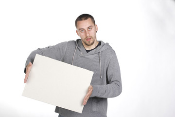 Young man holding a blank board on white background