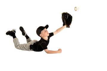 young baseball player diving to make an awesome catch