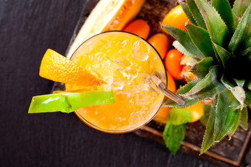 Summer orange cocktails on black stone