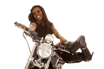 Naklejka na ściany i meble African American woman sit on motorcycle legs up looking