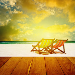 Beach chairs with summer sea and sunset sky