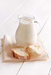 Fresh milk in jug and bread