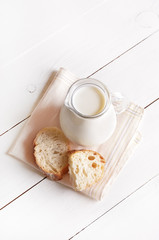 Milk in glass jug and bread