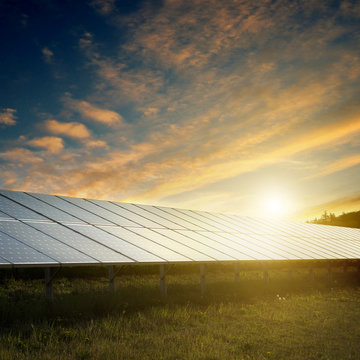 solar panels under sky on sunset