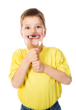 Boy showing teeth through a magnifying glass