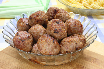 Fried pork meatballs in glass bowl