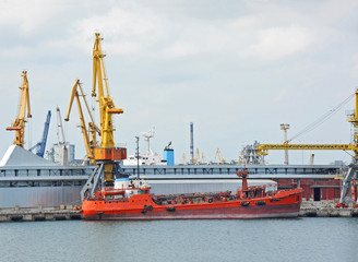 Fototapeta premium Bunker ship (fuel replenishment tanker) under port crane,