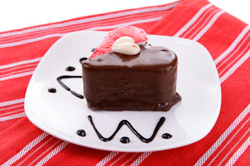 Sweet cake with chocolate on plate on table close-up
