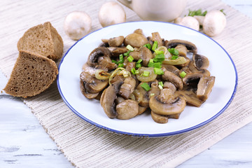 Delicious fried mushrooms on plate on table close-up