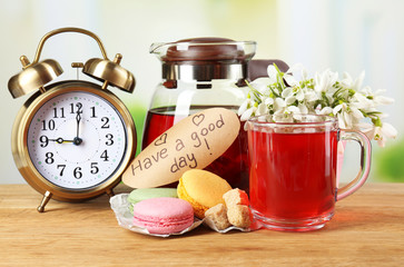Tasty herbal tea and cookies on wooden table
