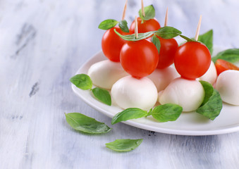 Tasty mozzarella cheese with basil and tomatoes