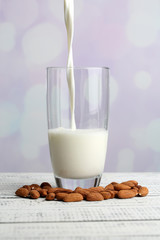 Almond milk is poured into glass,