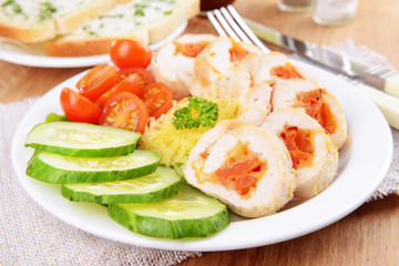 Delicious chicken roll on plate on table close-up
