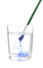 Brush with color paint in glass of water, isolated on white