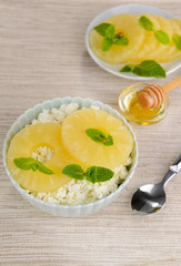 Bowl of tasty cottage cheese with pineapple, close up