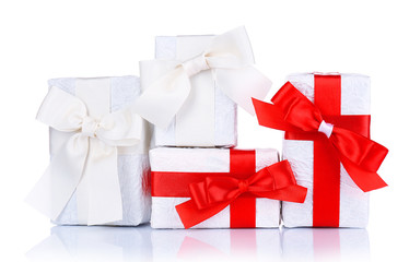 Beautiful gifts with red ribbons, isolated on white