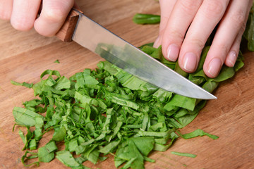 Chopped sorrel on wooden board close-up