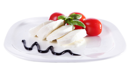 Caprese salad with mozarella cheese, tomatoes and basil