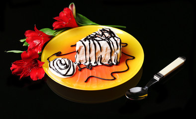 Tasty cake with cream, on black background © Africa Studio