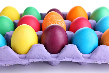 Colorful Easter eggs in tray close up