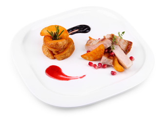 Grilled meat  with fried potato pieces and pomegranate seeds