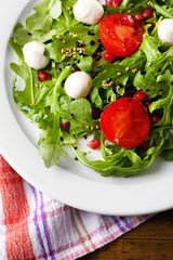 Green salad made with  arugula, tomatoes, cheese mozzarella