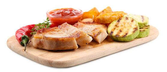 Grilled steak with fried potato pieces and grilled vegetables