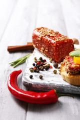 Composition of tasty sandwiches with salami sausage, basil leaf