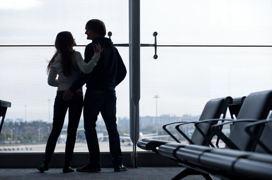 Silhouette of a couple at airport terminal