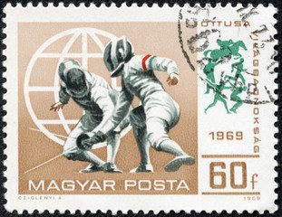 stamp printed in Hungary shows a fencing competitions