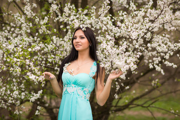 Girl in flowers of cherry