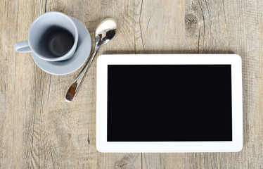 Fototapeta na wymiar digital tablet with a cup of coffee