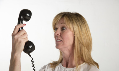 Angry woman shouting into a telephone