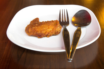 Fried chicken in cast iron pan closeup