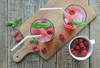 Glasses with rasberries juice and ice