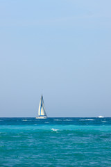 Small yacht with sail in Mediterranean Sea