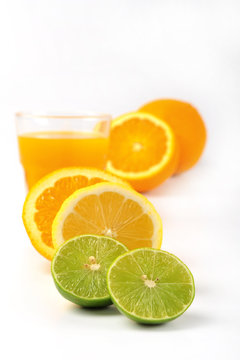 Orange juice and slices of orange and lemonade isolated on white