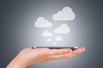 Hand Holding Smart Phone with Cloud Icons