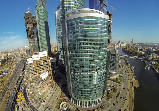 Cityscape with towers, construction buildings and river