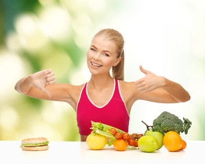 woman with fruits and hamburger comparing food