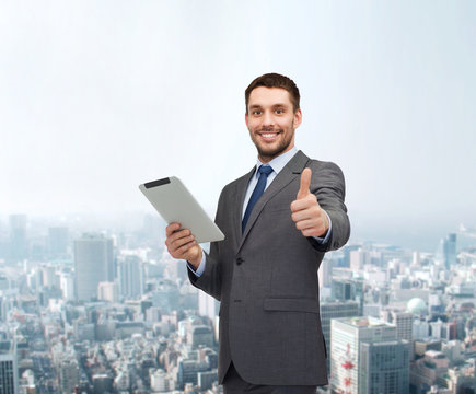 smiling buisnessman with tablet pc computer