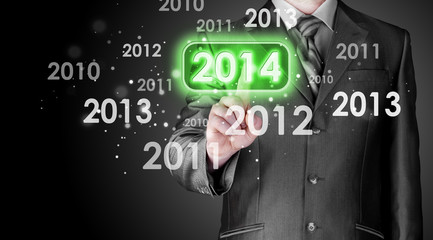 Businessman touching new year 2014
