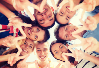 group of teenagers showing finger five gesture