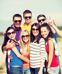 group of friends having fun on the beach