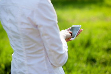 Closeup of woman hands using smartphone