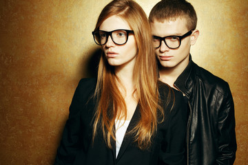 Eyewear concept. Red-haired fashion twins in trendy glasses